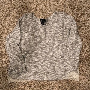 Black and white sweater with lace on sides at bottom